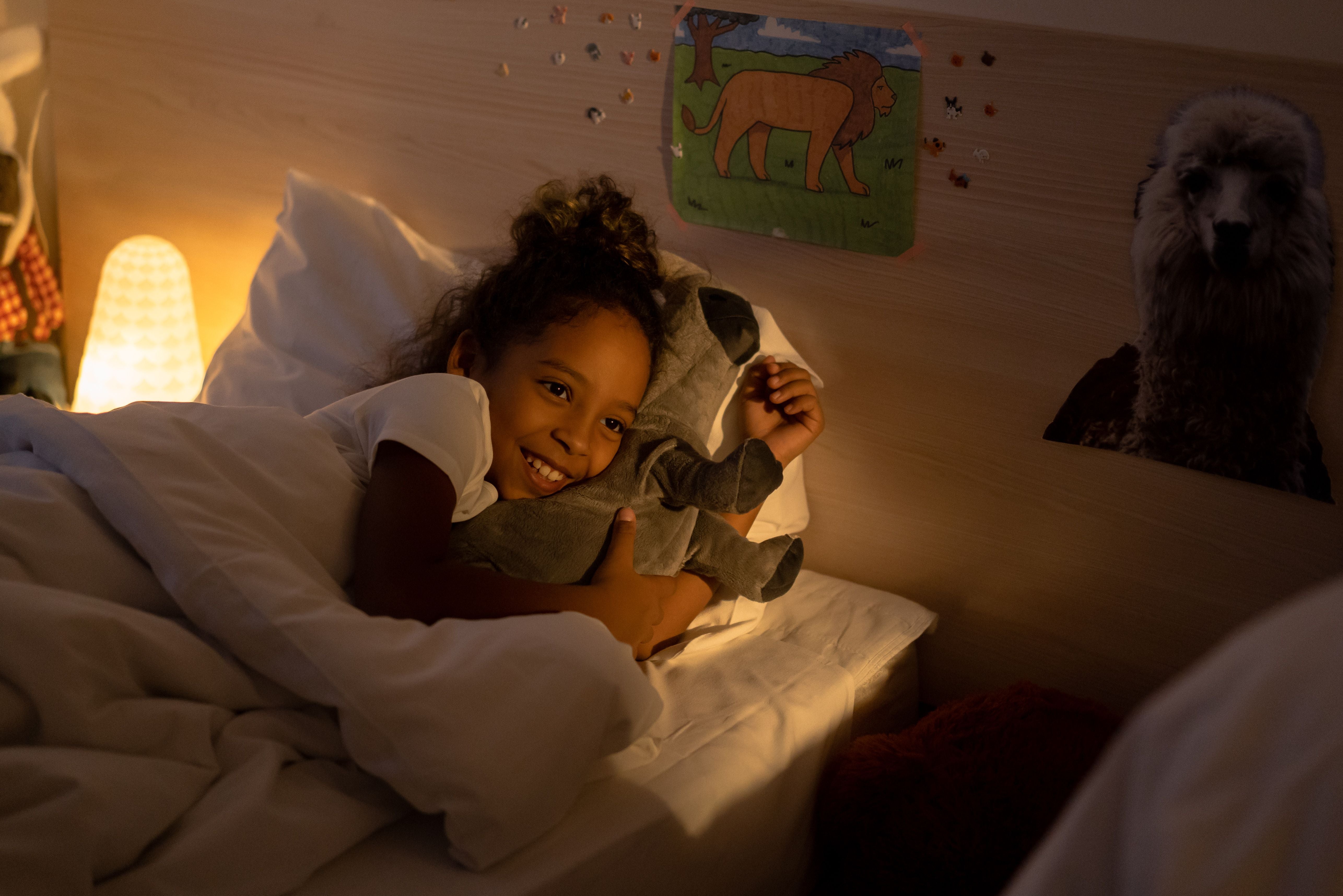 A child happily lying on a bed