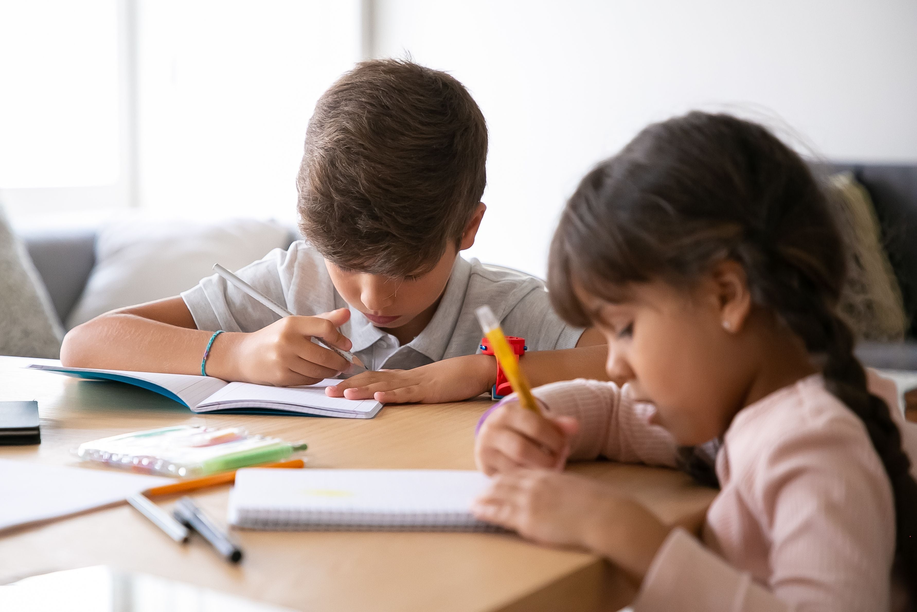 two kids studying at home