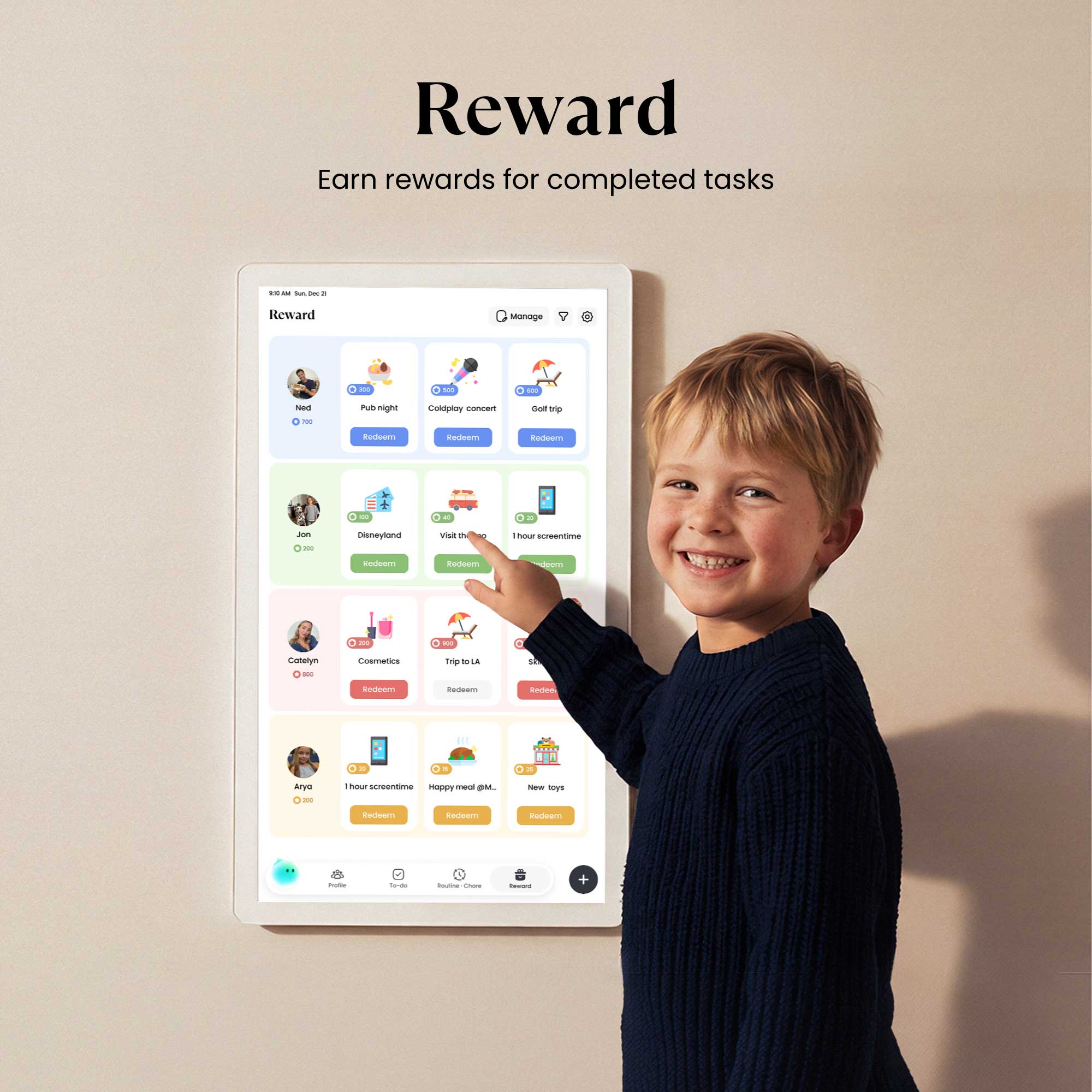 A child smiling and interacting with the Cozyla calendar+ 2 displaying the Reward system