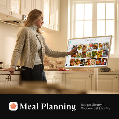 A happy lady checking the family's weekly meal plan on a Cozyla 32-in rechargeable digital calendar Plus Go